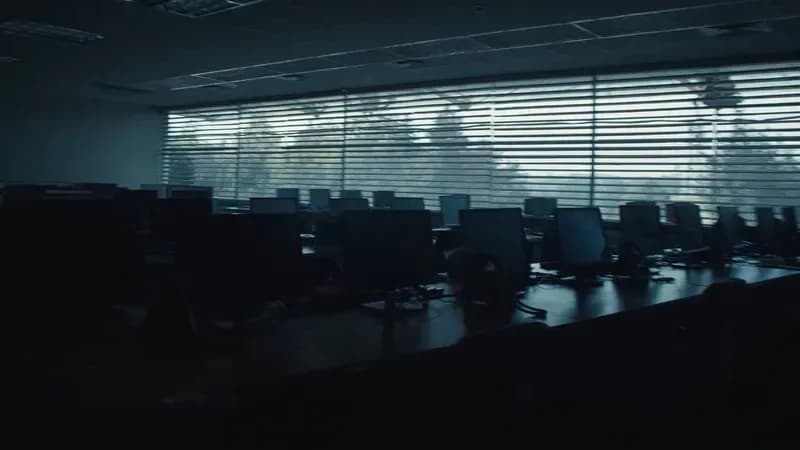 Quiet abandoned call center floor at dusk with unused headsets symbolizing voice AI cost floor reality